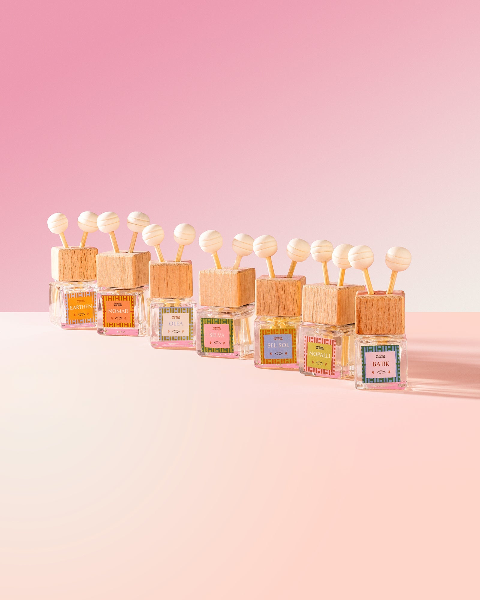 Assortment of car diffusers on a pink background. 