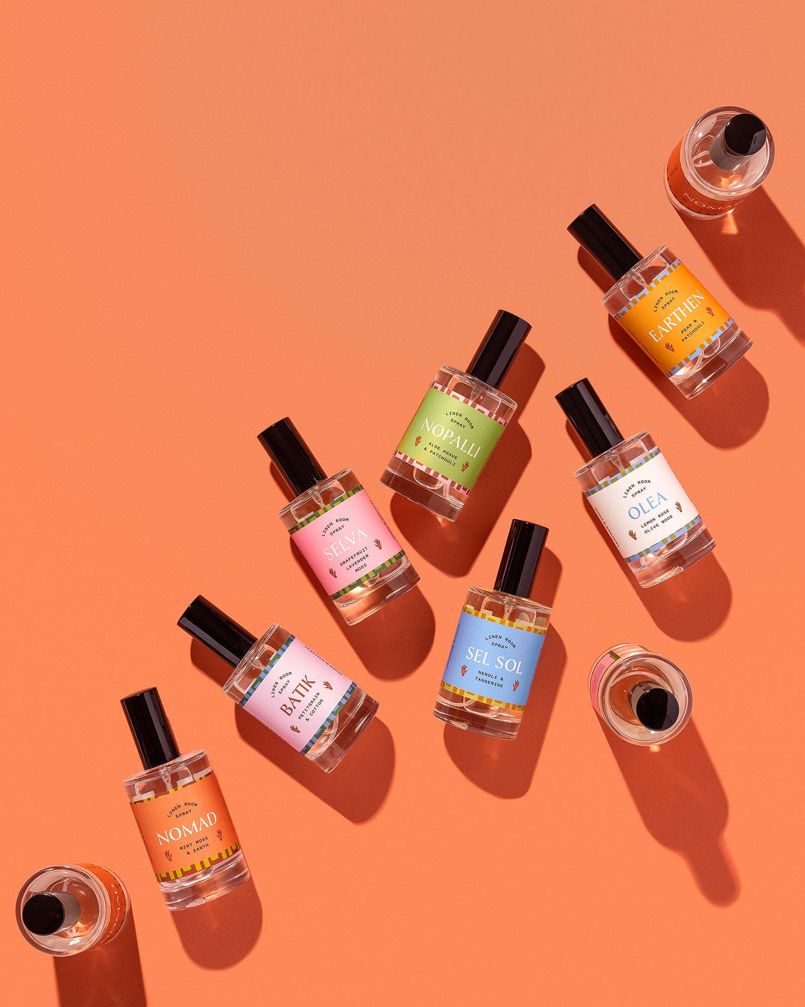 Assorted room sprays on an orange background. 
