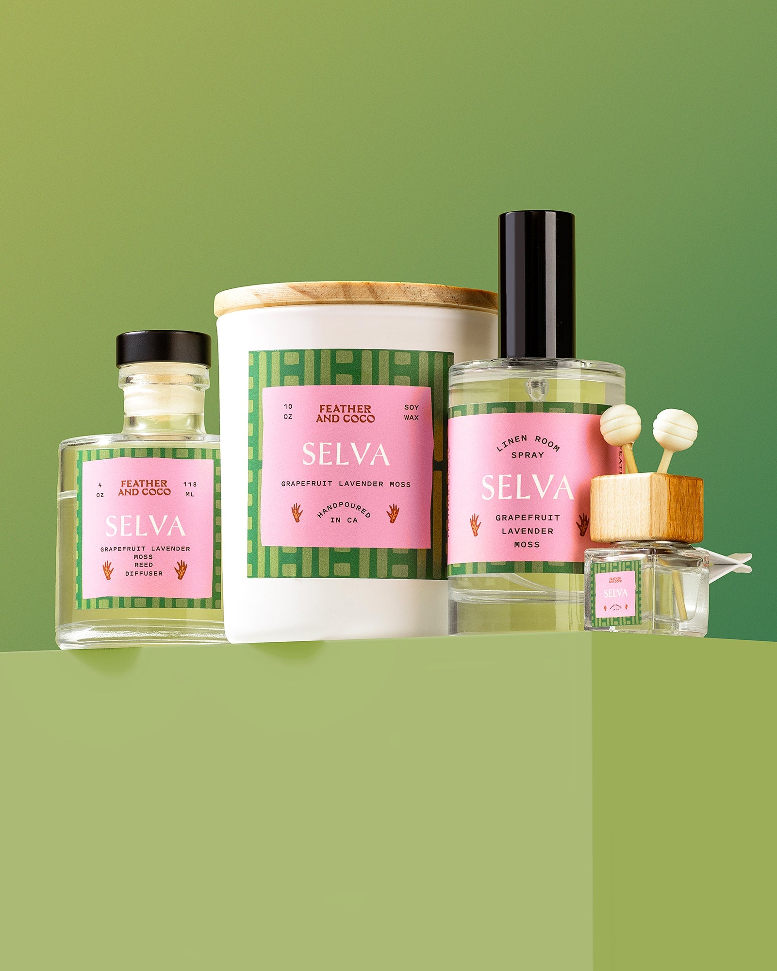 Collection of candles, sprays, and diffusers on a green background