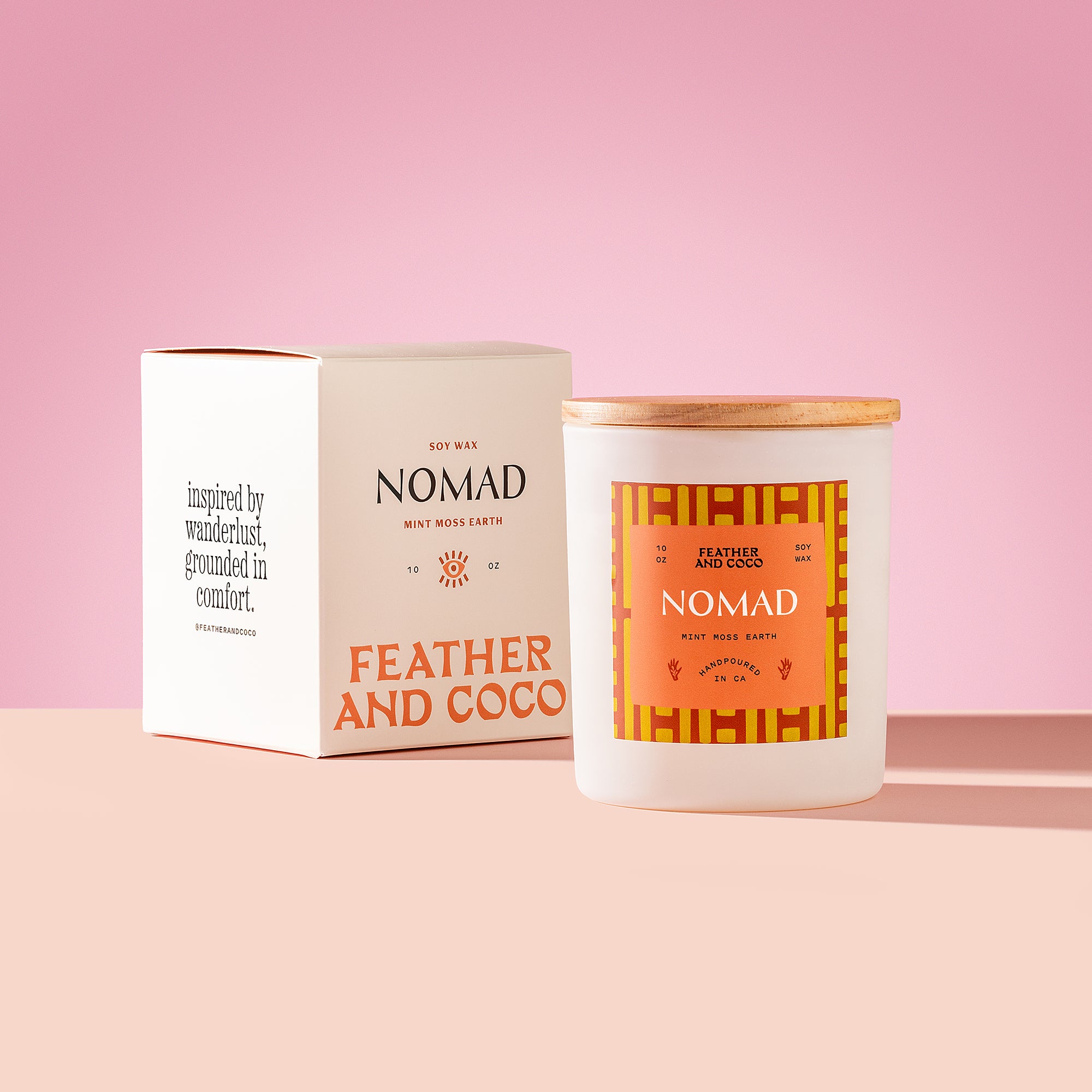 Nomad Candle with wooden lid on a pink background
