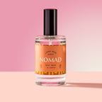 Nomad Spray in a glass bottle on a pink background