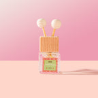 Nopalli Car Diffuser on a pink background. 