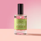 Nopalli Spray in a glass bottle on a pink background
