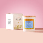 Sel Sol Candle with wooden lid on a pink background