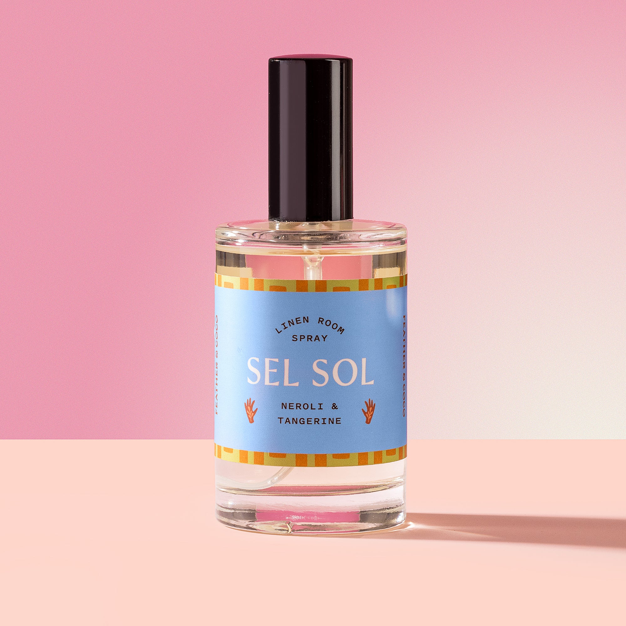 Sel Sol Spray in a glass bottle on a pink background