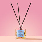 Sel Sol Reed Diffuser in a glass bottle on a pink background