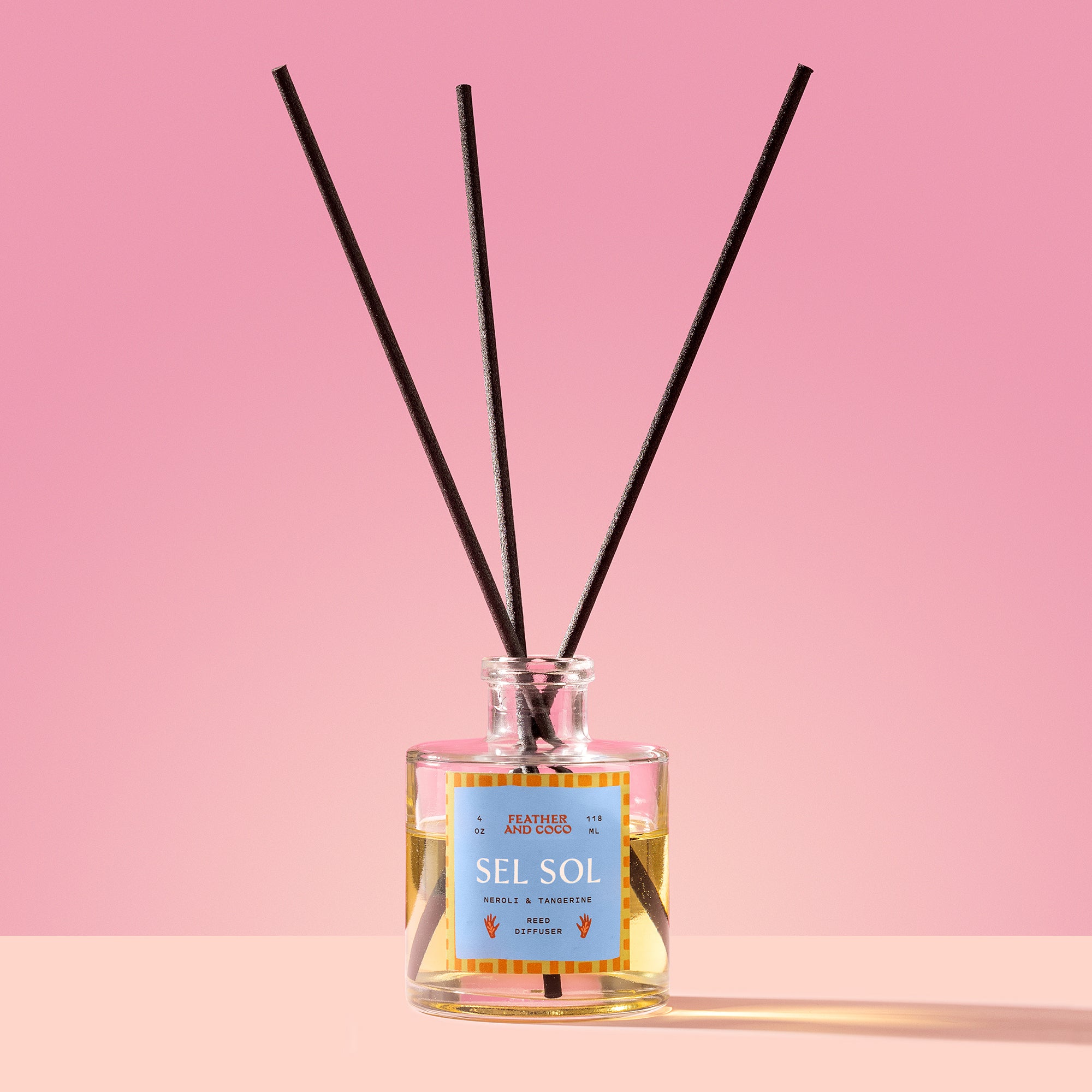 Sel Sol Reed Diffuser in a glass bottle on a pink background