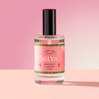 Selva Spray in a glass bottle on a pink background