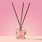 Selva Reed Diffuser in a glass bottle on a pink background