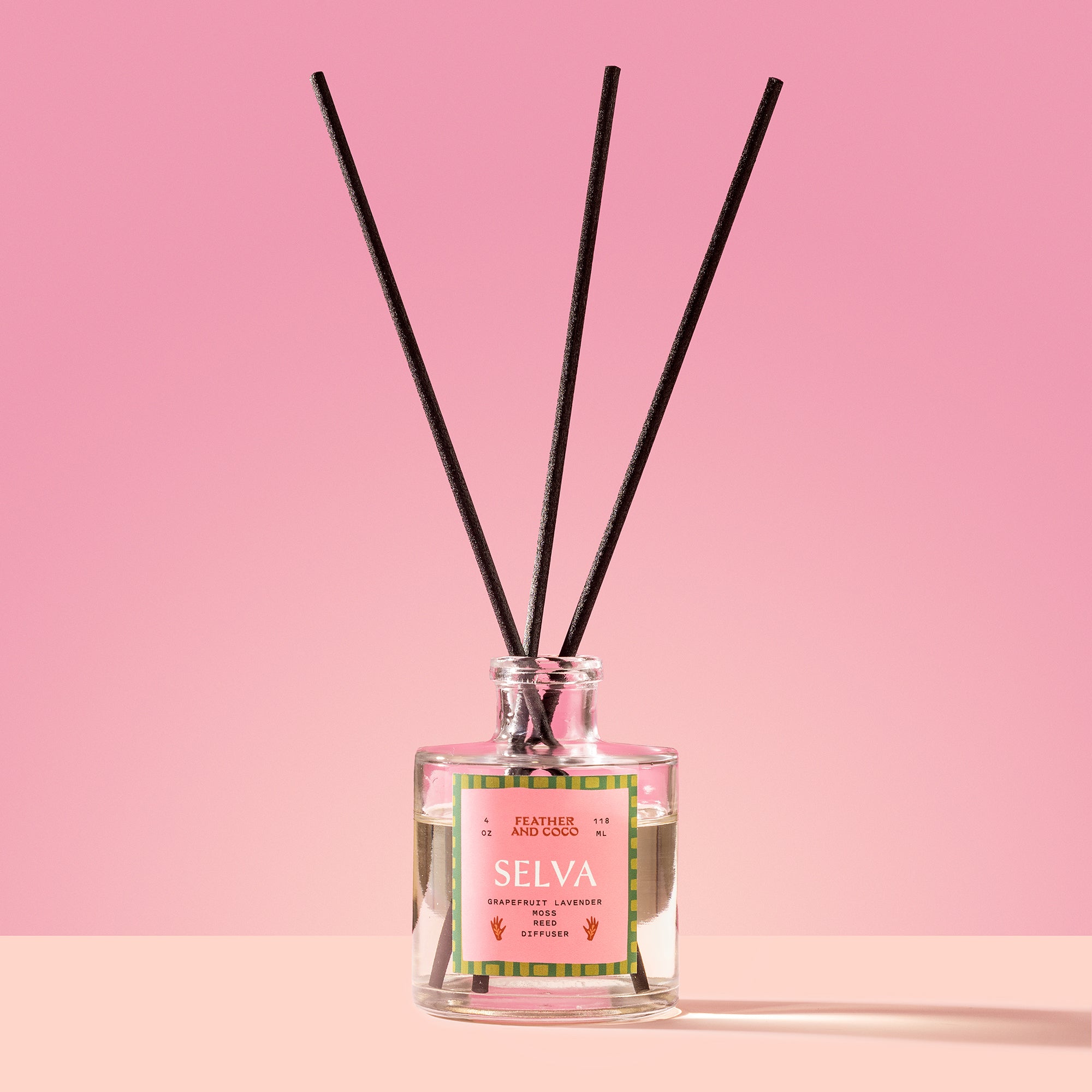 Selva Reed Diffuser in a glass bottle on a pink background