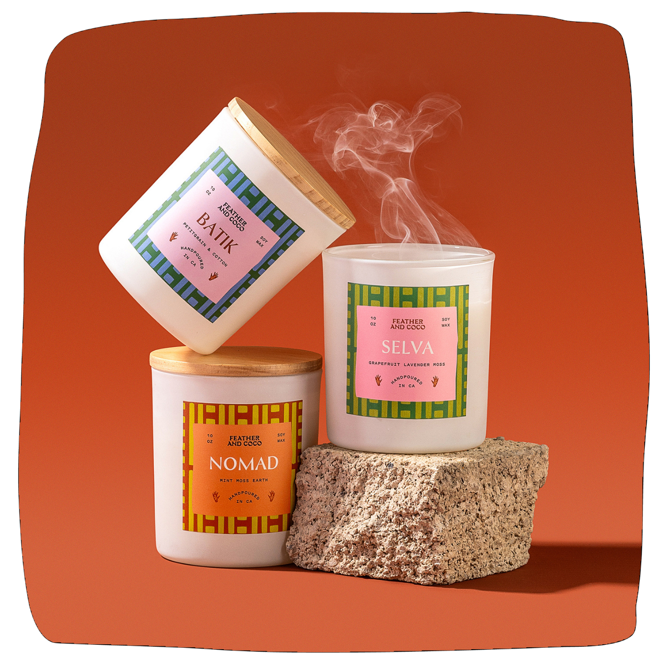 Three candles with different labels on an orange background